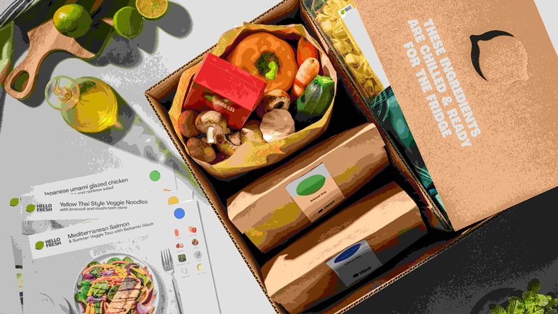 An open HelloFresh box with ingredients and recipe cards