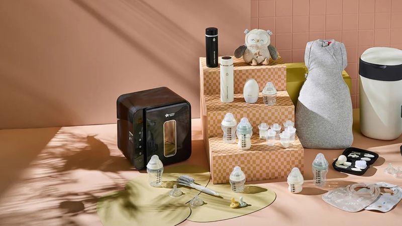 Tommee Tippee bottles, nappy bin and baby products laid out together